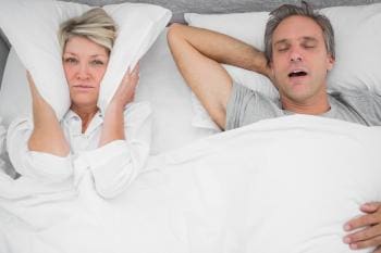 Man snoring whilst women struggles to sleep